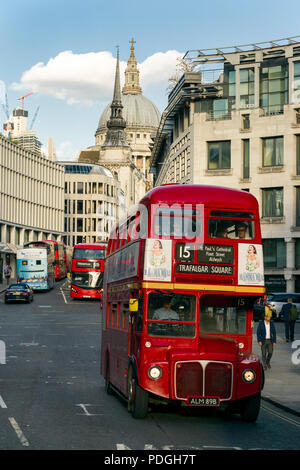 A London Heritage Route 15 AEC Routemaster red double-decker bus driving along Fleet Street with St. Pauls cathedral in background, London, UK