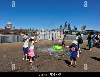 Children having fun with bubbles, Southbank, London, England, UK Stock Photo