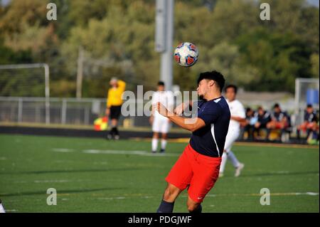 Player executing a header during a high school soccer match. USA. Stock Photo