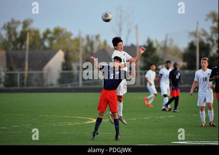 Player executing a header during a high school soccer match. USA. Stock Photo