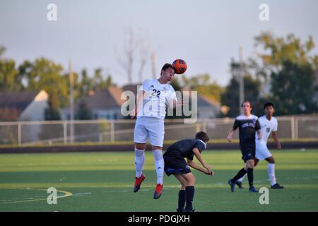 Player executing a header above an opponent. USA. Stock Photo