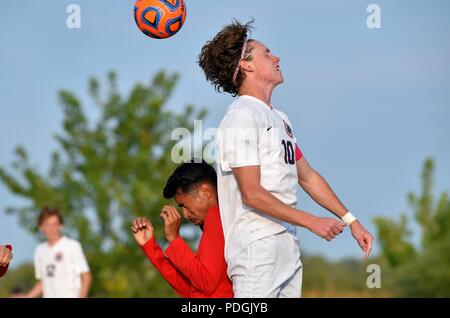 Player rising above an opponent in an effort to execute a header. USA. Stock Photo