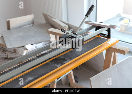 Cutter machine for ceramic tiles. A flat during renovation. Stock Photo