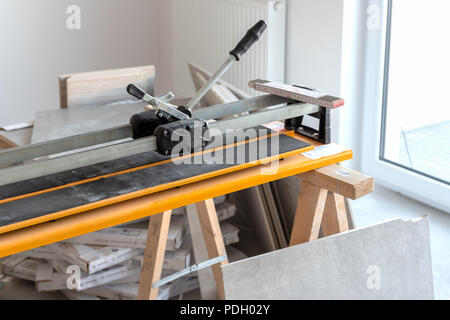 Cutter machine for ceramic tiles. A flat during renovation. Stock Photo