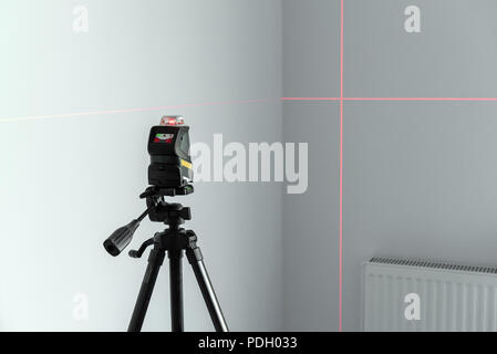 Laser spirit level during finishing works in flat. Stock Photo