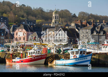 Two colourful fishing boats moored on the quayside with the St. Leonard's Church behind, Honfleur, Normandy, France Stock Photo