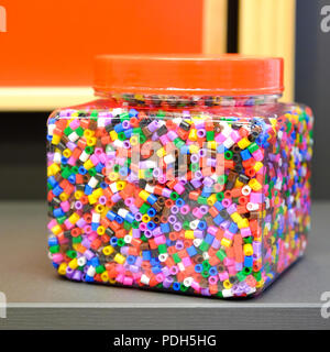 Children's colorful beads for peyote stitch. Big plastic jar. For different crafts. Stock Photo