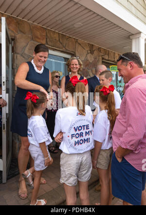 Massapequa, New York, USA. 5th Aug, 2018. Massapequa, New York, USA. August 5, 2018. L-R, JOANNE CURRAN PERRUCCI, candidate for Court Judge 4th District; and LAURA CURRAN, Nasssau County Executive, are smiling with Perrucci's four children, at opening of fellow Democrats' campaign office, aiming for a Democratic Blue Wave in November midterm elections. Credit: Ann Parry/ZUMA Wire/Alamy Live News Stock Photo