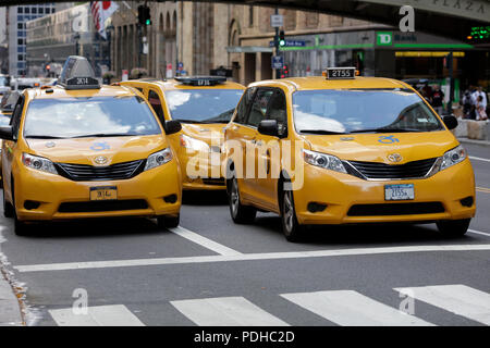 New York, USA. 9th Aug, 2018. Yellow cabs are seen on a street in Manhattan, New York City, the United States, Aug. 9, 2018. New York City Council passed regulations on for-hire vehicle industry on Wednesday, placing a year-long cap on the number of for-hire vehicles on the road. The app-based transportation industry in New York City includes about 80,000 vehicles, dwarfing the city's 13,587 medallion taxis, according to a latest study by the New School for the Taxi and Limousine Commission. Credit: Li Muzi/Xinhua/Alamy Live News Stock Photo