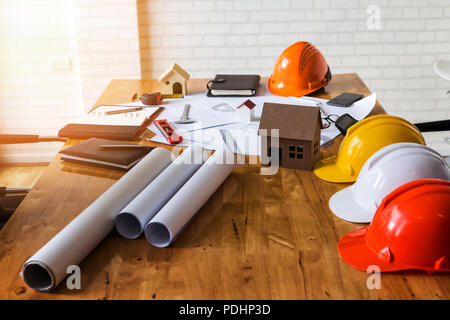 A architects house model with plan and blueprints Stock Photo