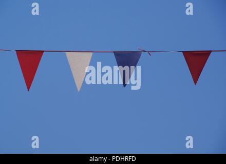 Red, White and Blue Bunting Flags against a Blue Summer Sky. Sidmouth Folk Festival, East Devon, UK. Summer, 2018. Stock Photo
