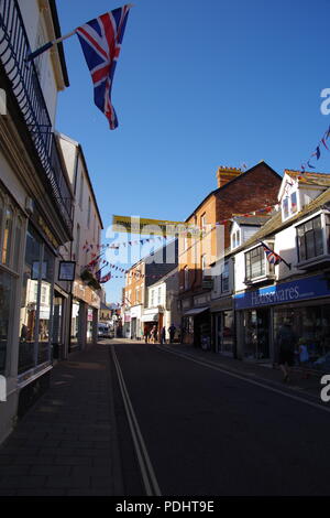 Union Jack and Bunting Flying Over Fore Street at Sidmouth Folk Festival, East Devon, UK. August, 2018. Stock Photo