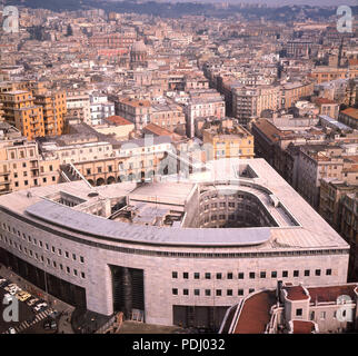 1960s, historical, view from above across the ancient Italian city of Naples, showing in the foreground the 'Palazzo delle Post', the Main Post Office building, constructed in 1936 during the fascist government of Benito Mussolini but which suffered a violent explosion during WW2 due to time bombs having been left by the retreating Nazis. Stock Photo