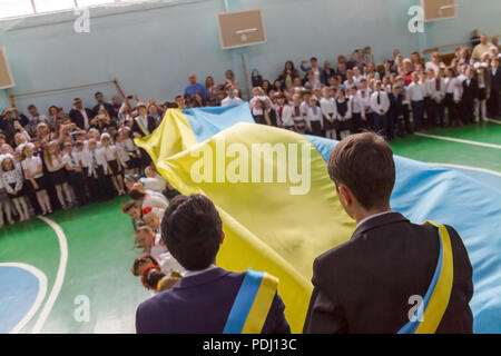 Kiev.Ukraine, May 26,2017-Children schoolchildren on a parade-line dance in embroideries against the background of the Ukrainian flag.