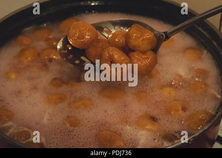 Making of homemade fig jam. Boiled figs in a spoon. Stock Photo