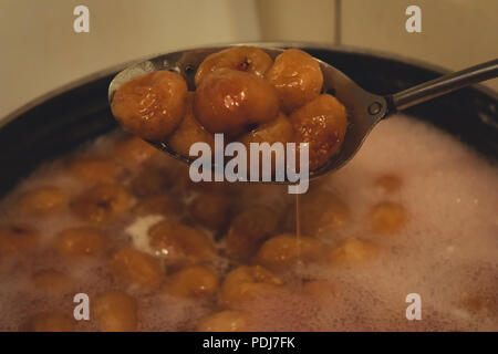 Making of homemade fig jam. Boiled figs in a spoon. Stock Photo