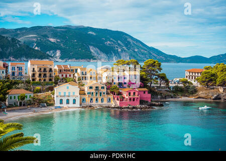 Assos village. Beautiful view to vivid colorful houses near blue turquoise colored transparent bay lagoon. Kefalonia, Greece Stock Photo