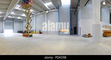 New factory hall with hydraulic scissors lift platform Stock Photo