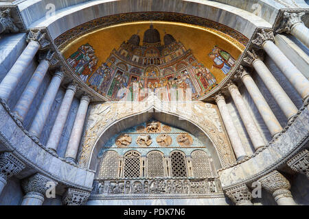 Venice, San Marco basilica facade details with golden, colorful mosaics and marble columns in Italy Stock Photo