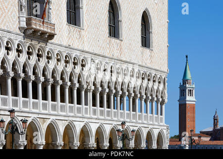 Venice, Doge palace facade and San Giorgio Maggiore bell tower in a sunny day in Italy Stock Photo