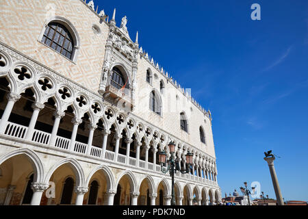 Venice, white Doge palace facade and San Marco lion statue on column in a sunny day, clear blue sky in Italy Stock Photo