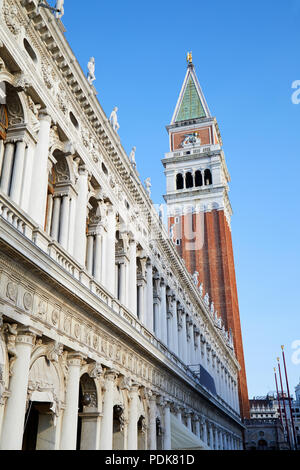 Venice, National Marciana library building and San Marco bell tower, blue sky in a sunny day in Italy Stock Photo