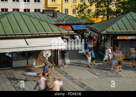 Munich, Germany - July 29, 2018: High perspective of locals and tourists enjoy beer and food at an open air beer garden in Viktualienmarkt Stock Photo
