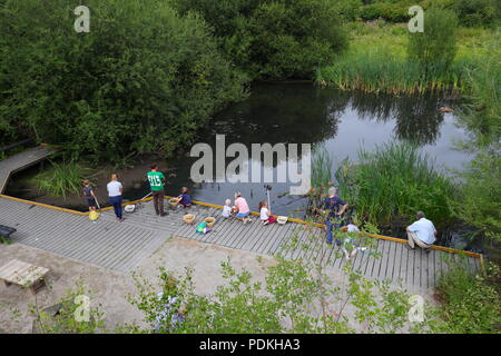 Families pond dipping on a nature trail at RSPB Fairburn Ings Nature Reserve Stock Photo
