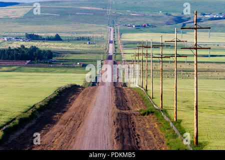 A country road in a rural landscape in Pincher Creek, Alberta, Canada. Stock Photo