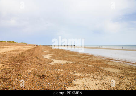 Pebble ridge on sand at West Beach, Littlehampton, a small holiday resort on the south coast in West Sussex, UK in summer Stock Photo