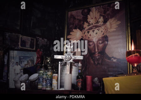 Black magic Brujos or witch doctors, in Catemaco, Veracruz.  Surrounded by dried animals, candles and other objects of black witch craft in Catemaco, Mexico. Stock Photo