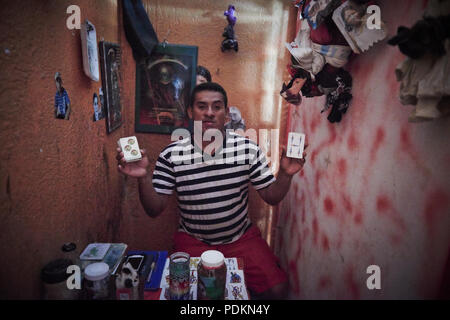 Black magic Brujos or witch doctors, in Catemaco, Veracruz.  Surrounded by dried animals, candles and other objects of black witch craft in Catemaco, Mexico. Stock Photo