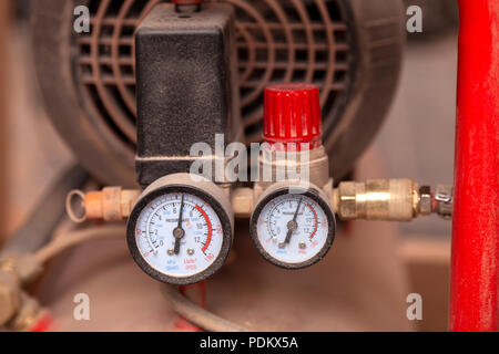 Close-up of a reducer and a pressure sensor  on modern equipment in the factory  in the background industrial workshop, side view Stock Photo
