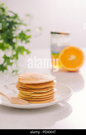 Stack of delicious pancakes on plate isolated on white Stock Photo
