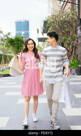 Portrait of happy couple with shopping bags after shopping in city Stock Photo
