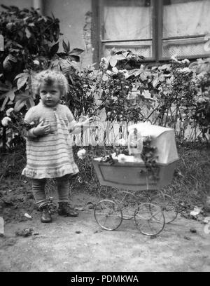 kid-toy-baby-carriage-girl-garden-flower-12123-stock-photo-alamy