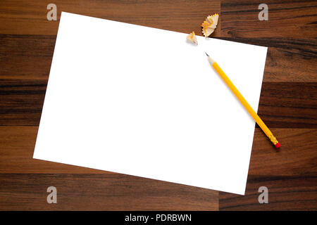 blank page of paper, sharpened pencil and it's shavings on wooden desk, view from above Stock Photo