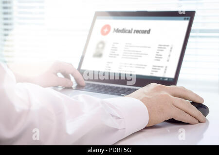 Doctor using laptop and electronic medical record (EMR) system. Digital database of patient's health care and personal information on computer screen. Stock Photo