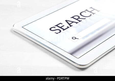 Search engine app on tablet screen. Application to find website or service with smart mobile device. Stock Photo