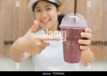 cute teen hand holding healthy drink in summer fruity blueberry smoothie Stock Photo