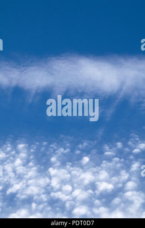 Streaky and puffy Cirrocumulus Clouds against blue sky. Portrait orientation. Stock Photo