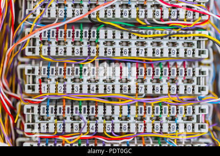 Complex massy managed colorful telephone cable lines in analog PBX box Stock Photo