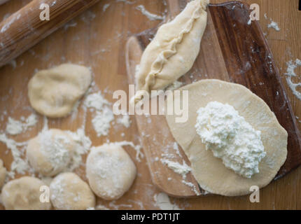 Cooking pies with cheese. Homemade baking. Top view. Stock Photo