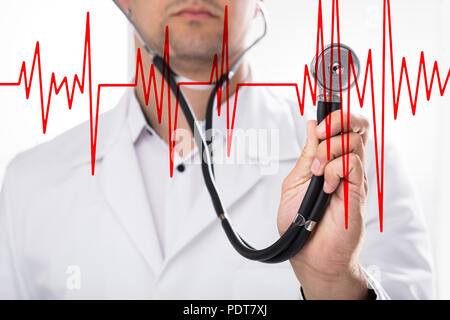 Close-up of a doctor's hand holding heart rate with stethoscope Stock Photo