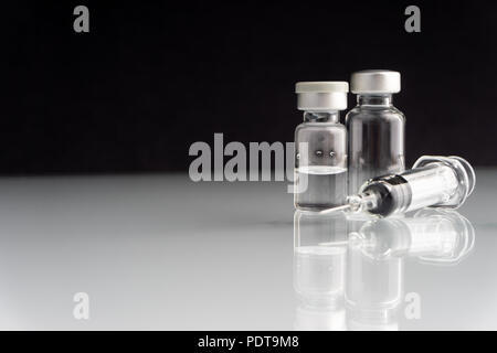 Syringe and vials closeup with selective focus and crop fragment. Medical and Healthcare Concept Stock Photo