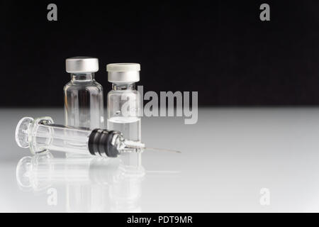 Syringe and vials closeup with selective focus and crop fragment. Medical and Healthcare Concept Stock Photo