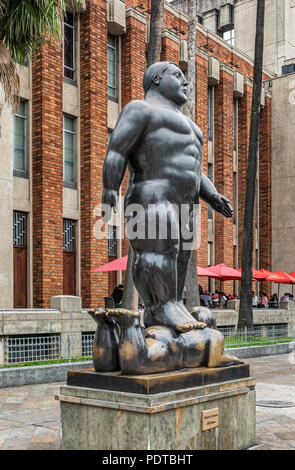 Medellin, Colombia, March 29, 2018: Tourists walking by Botero sculptures located at Botero Plaza in Medellin. Botero donated 23 sculptures to his hom Stock Photo