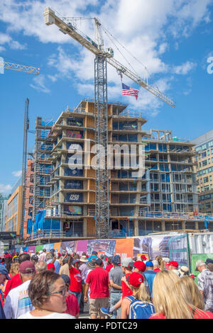 Baseball fans walk on Half St SE past new construction near Nationals Park in Washington, DC. Stock Photo