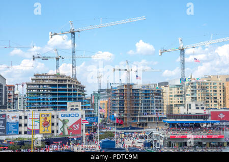 Seen from Nationals Park, construction cranes dominate new buildings in the rapidly developing Navy Yard neighborhood in Washington DC. Stock Photo