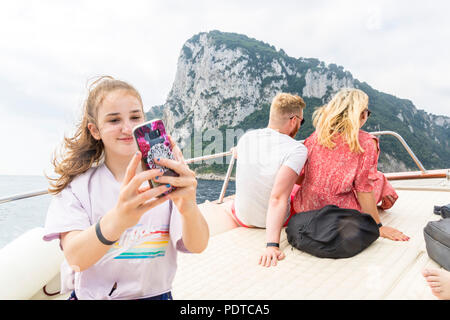 Girl taking a selfie cruise boat, sea water background, travel concept, summer concept, Amalfi Italy, happy living, best life, teen girl, teenager Stock Photo
